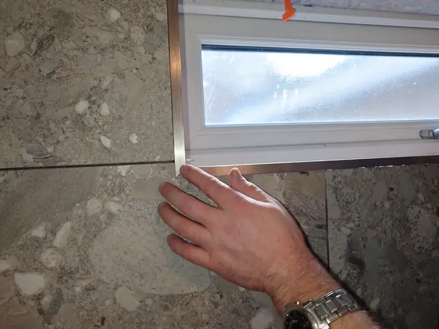 Checking the window sill tile sits flush against the trim