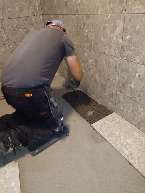 Laying the first floor tiles against the finished walls